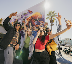 group taking a selfie in front of mural in downtown sarasota